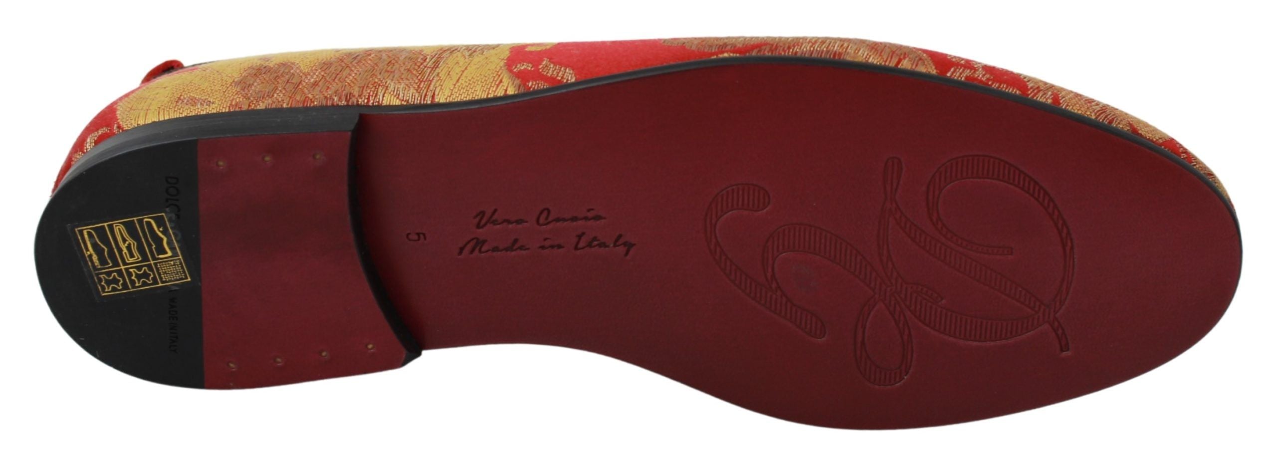 Red gold brocade Dolce & Gabbana loafers with a luxurious slip-on design and intricate pattern.