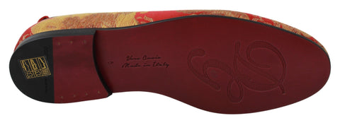 Red gold brocade Dolce & Gabbana loafers with a luxurious slip-on design and intricate pattern.