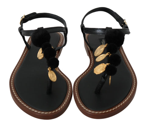 Black leather Dolce & Gabbana coins flip flops with thong straps and flat soles, stylish summer sandals for casual wear.