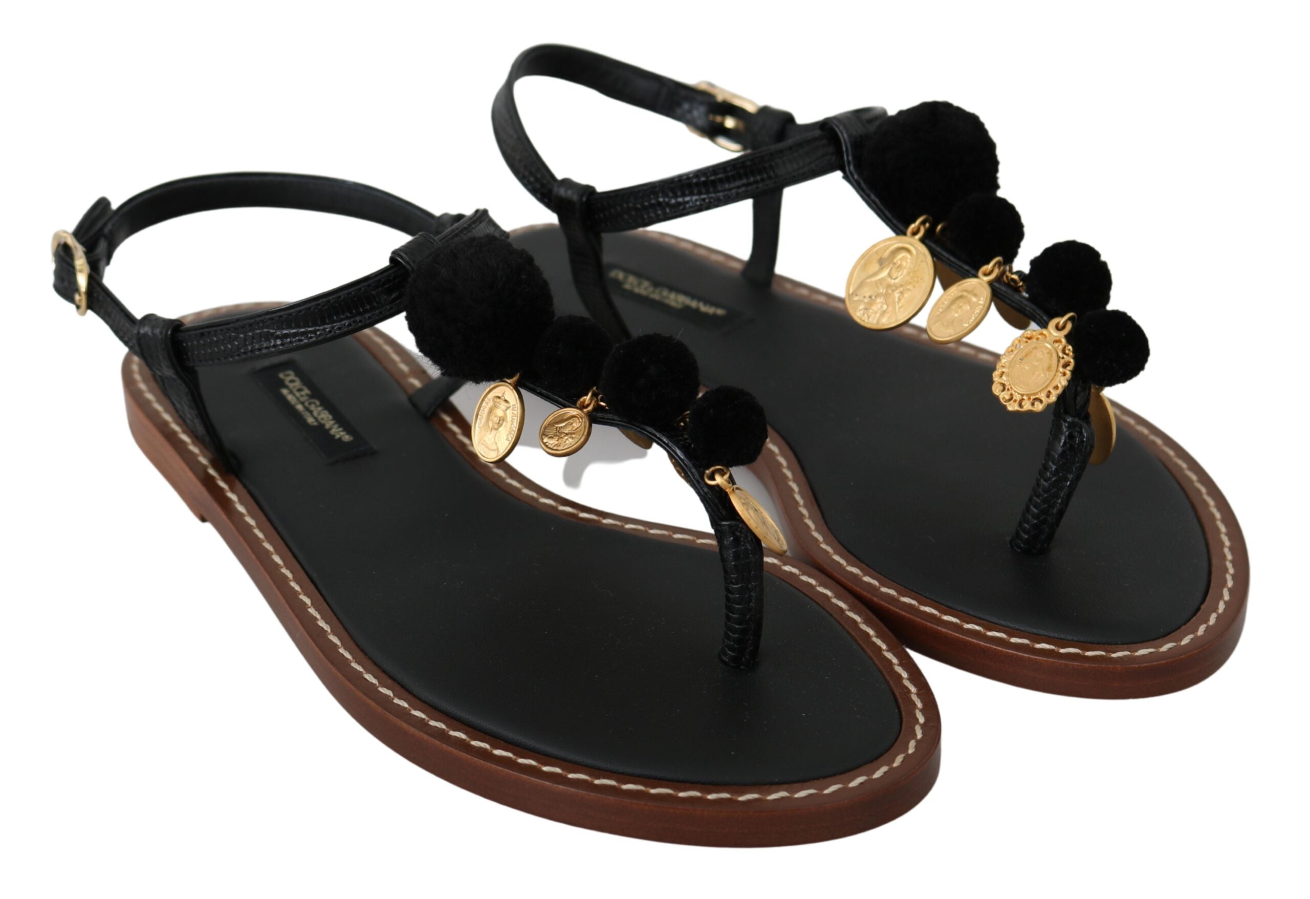 Black leather Dolce & Gabbana coins flip flops with thong sandal design and textured sole.
