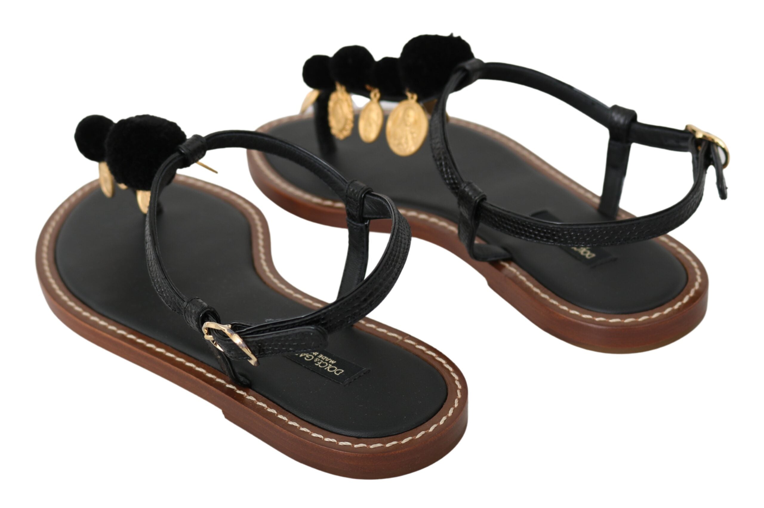Black leather Dolce & Gabbana coins flip flop sandals with thong straps and flat sole, stylish summer footwear.