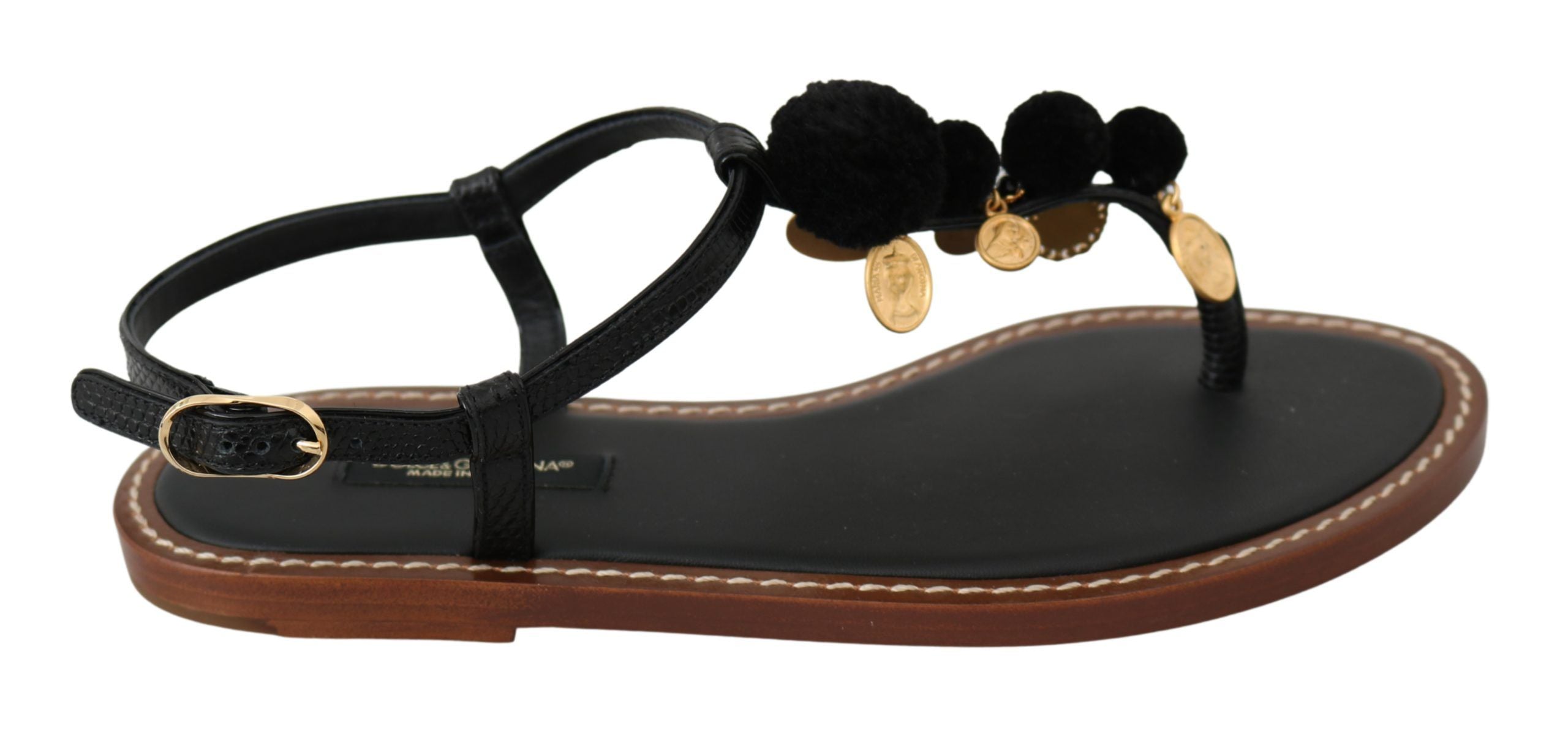 Black leather Dolce & Gabbana flip flop sandals with coin details and thong style for casual summer wear.
