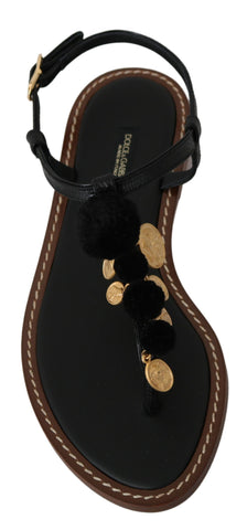 Black leather Dolce & Gabbana coins flip flops sandals with thong design and textured sole, casual summer footwear.