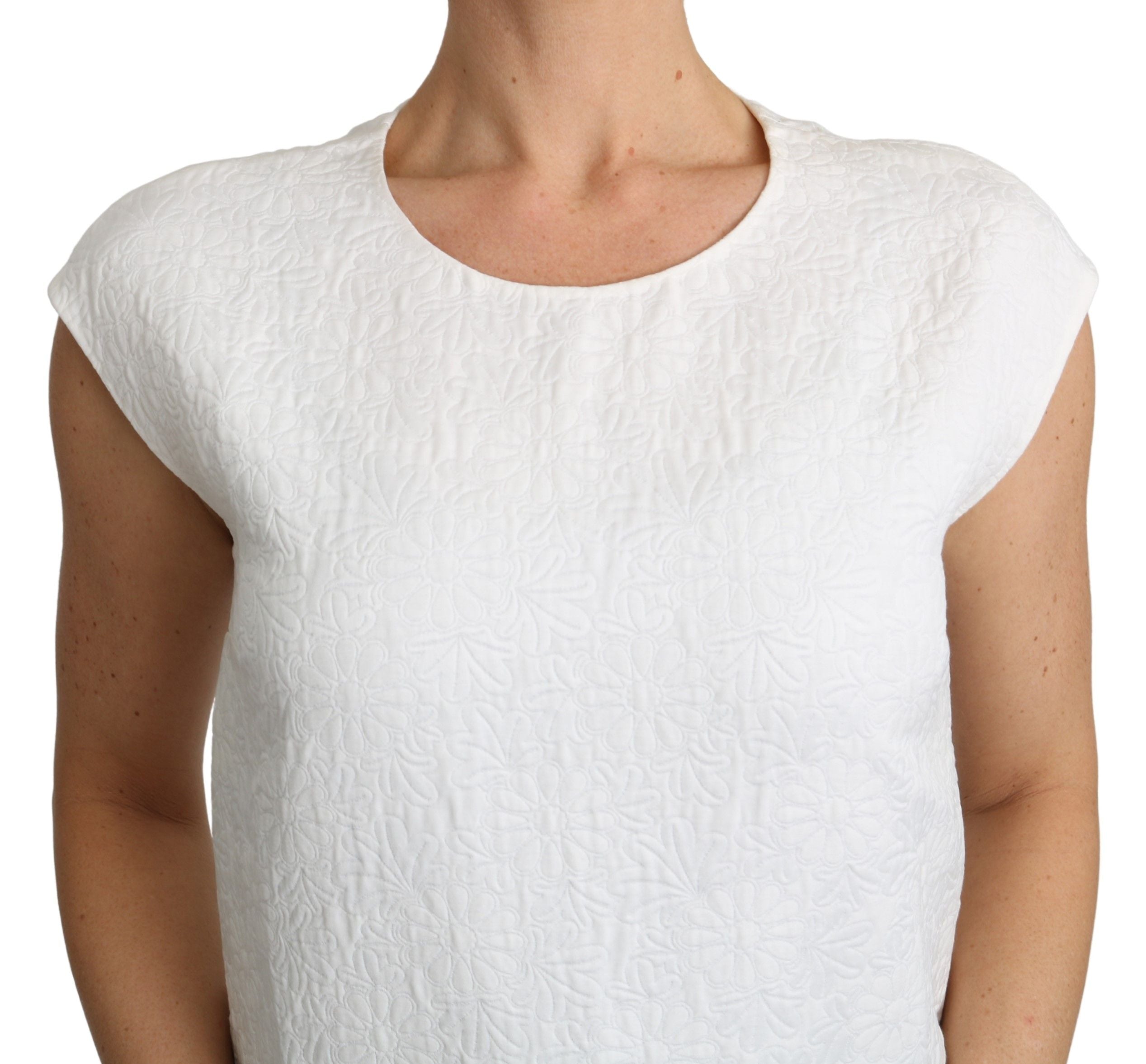 White floral brocade blouse made of cotton by Dolce & Gabbana, featuring intricate floral patterns and a stylish neckline.
