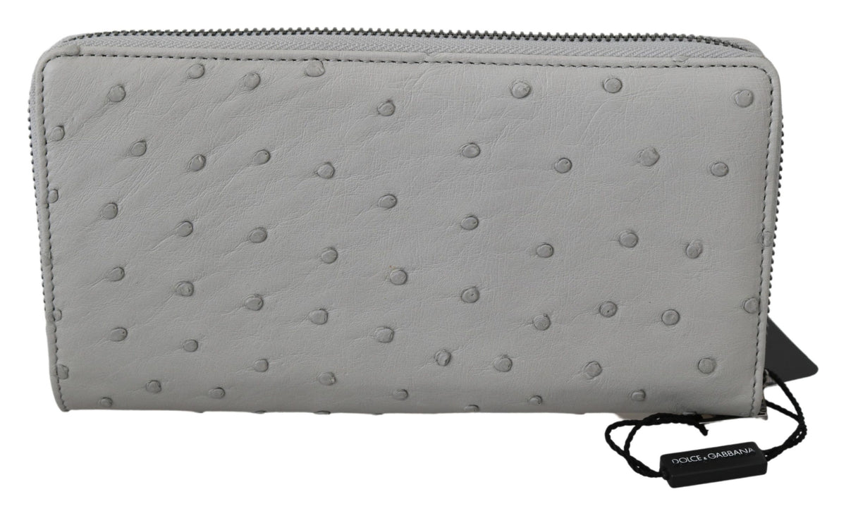 White ostrich leather men's clutch wallet with continental design by Dolce & Gabbana, featuring multiple card slots and a sleek finish.