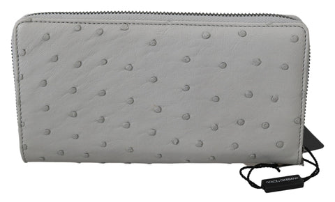 White ostrich leather men's clutch wallet with continental design by Dolce & Gabbana, featuring multiple card slots and a sleek finish.