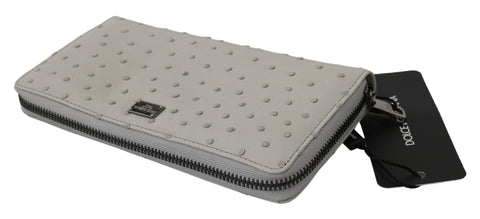 White ostrich leather men's clutch wallet by Dolce & Gabbana, featuring a sleek, textured finish and multiple card slots.
