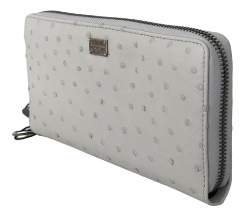 White ostrich leather men's clutch wallet by Dolce & Gabbana, featuring a sleek, textured design with multiple card slots.