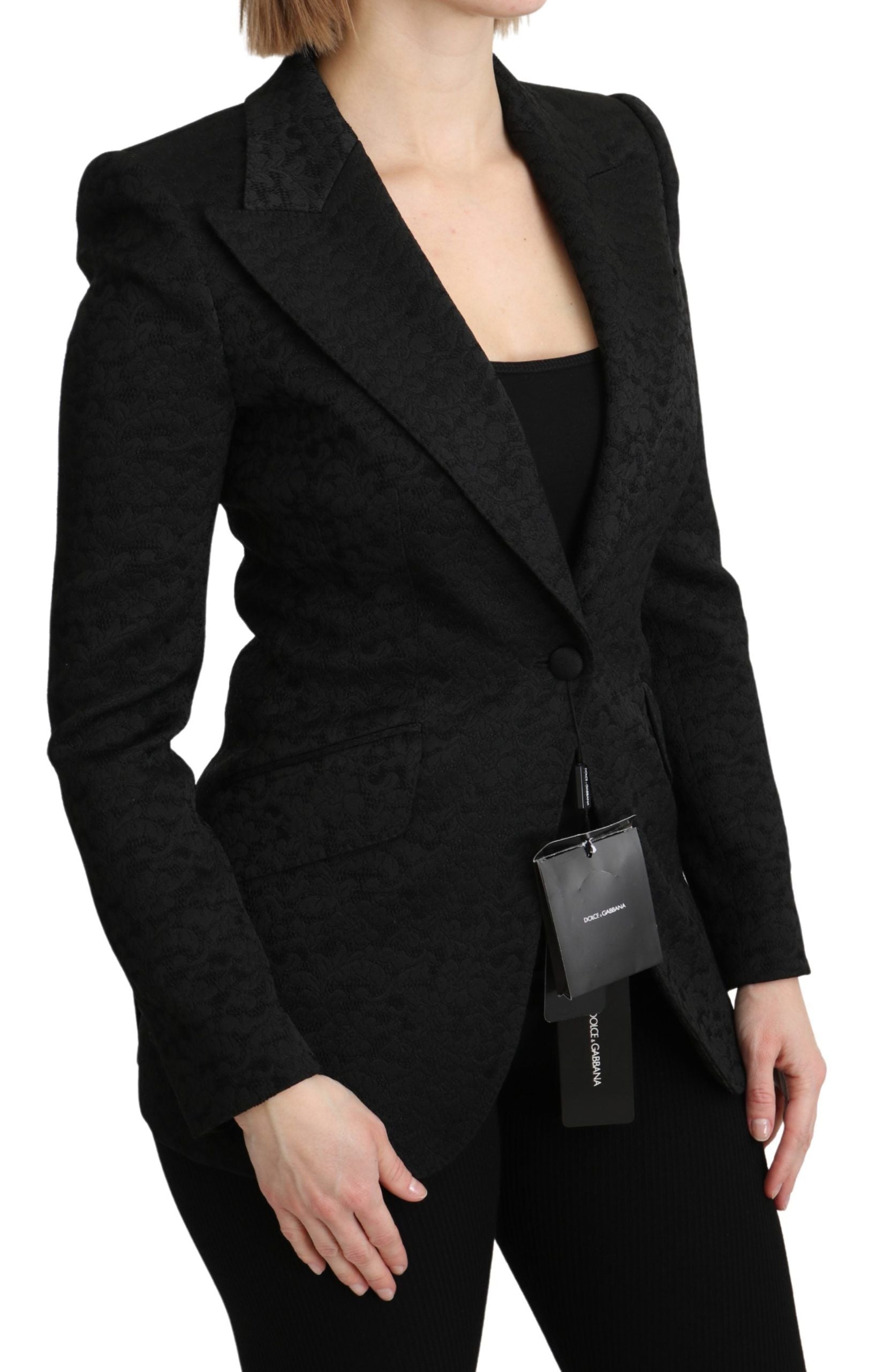 Black brocade single-breasted blazer jacket by Dolce & Gabbana with detailed floral pattern and tailored fit.