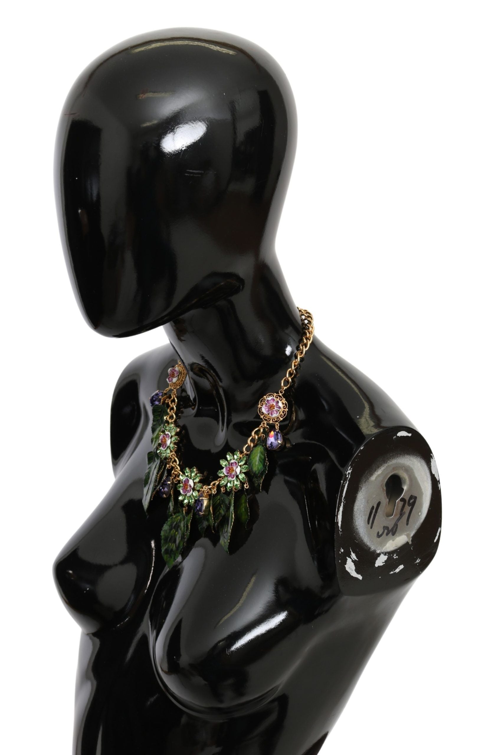 Gold brass flower pendant necklace with green leaves and crystal accents from Dolce & Gabbana, featuring a detailed floral design.