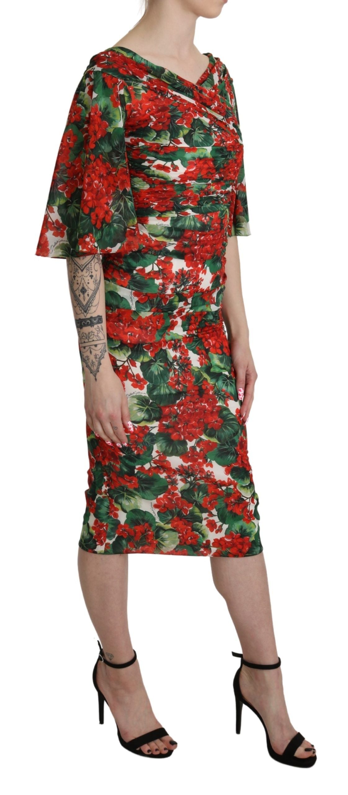 Red floral sheath midi silk stretch dress by Dolce & Gabbana displayed on a hanger with intricate floral patterns.