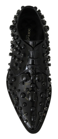 Black leather brogue shoes with crystal embellishments by Dolce & Gabbana, featuring classic design and detailed stitching.