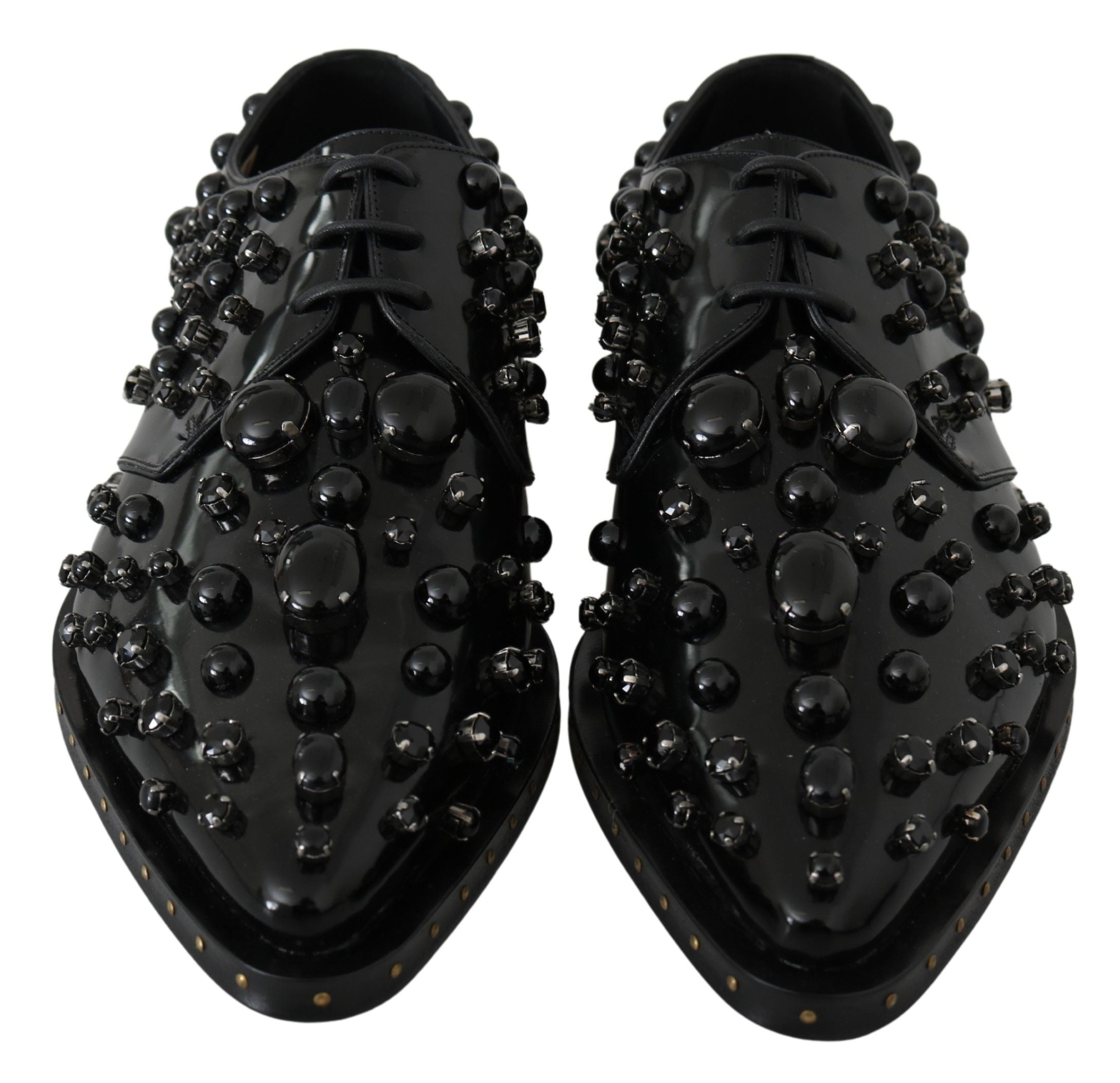 Black leather brogue shoes with crystal embellishments from Dolce & Gabbana, featuring detailed stitching and classic wingtip design.