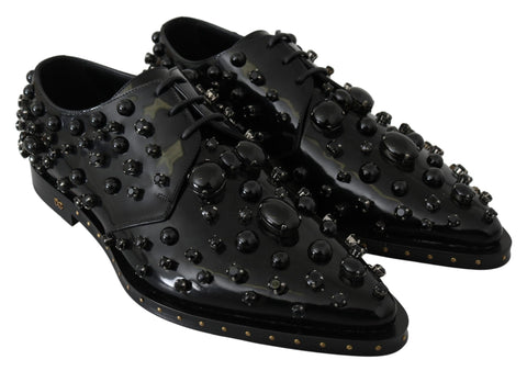 Black leather brogue shoes with crystal embellishments from Dolce & Gabbana, featuring detailed stitching and classic design.