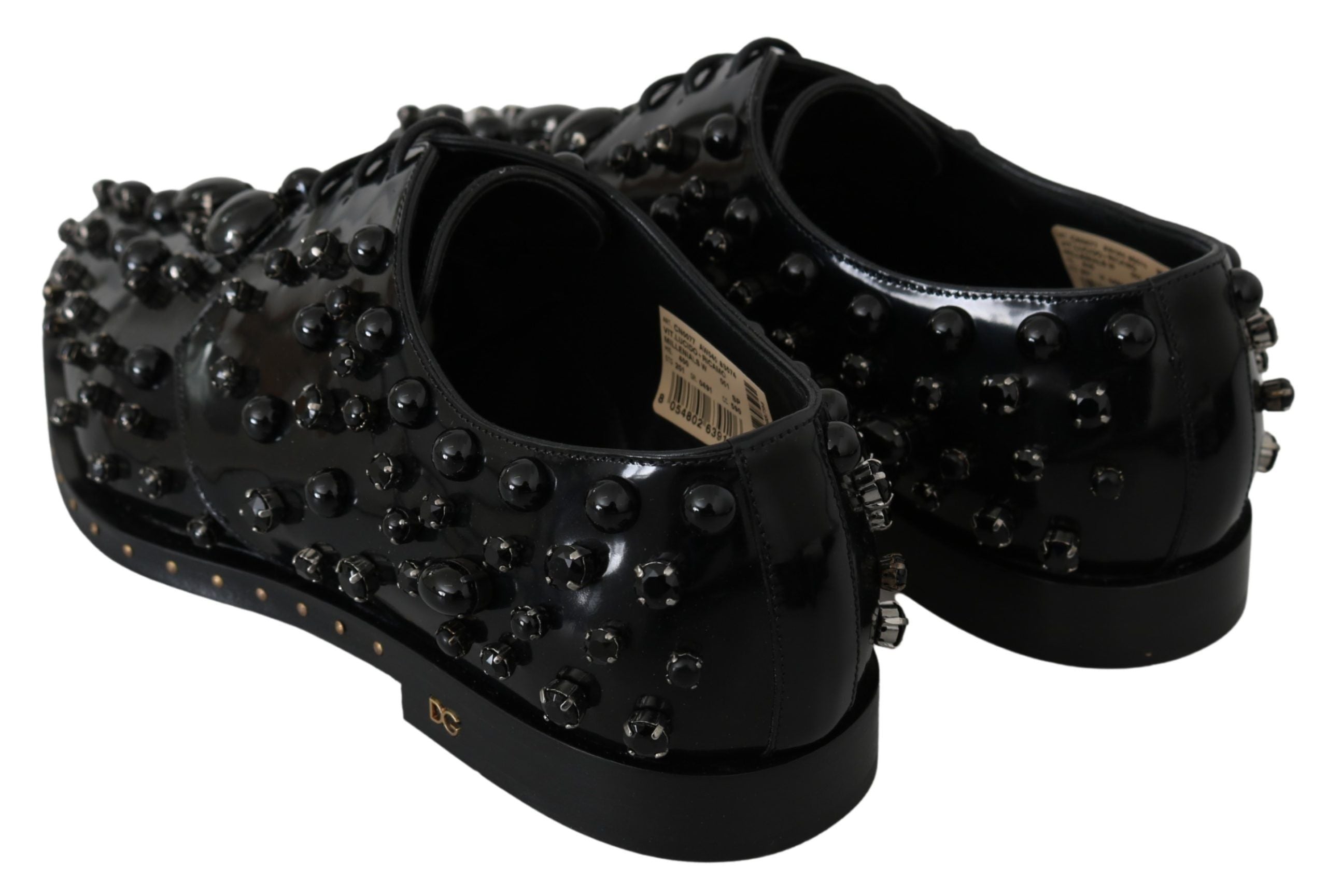 Black leather brogue shoes with crystal embellishments from Dolce & Gabbana, featuring detailed stitching and classic style.