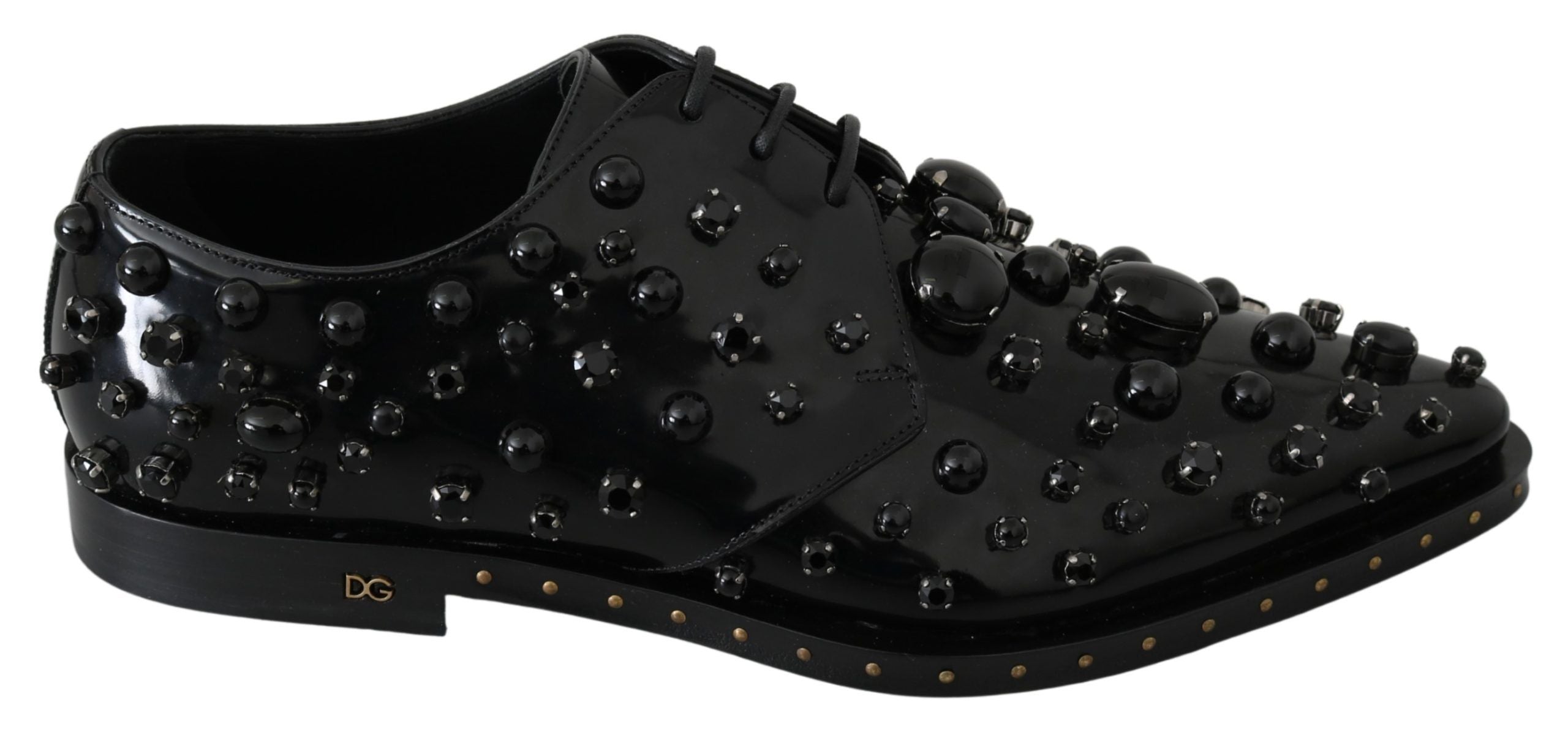 Black leather brogue shoes with crystal embellishments by Dolce & Gabbana, featuring detailed stitching and classic design.