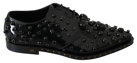 Black leather brogue shoes with crystal embellishments by Dolce & Gabbana, featuring detailed stitching and classic design.
