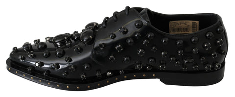 Black leather brogue shoes with crystal embellishments by Dolce & Gabbana, featuring detailed stitching and classic wingtip design.