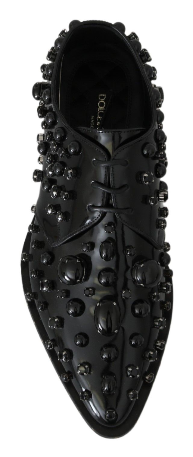Black leather brogue shoes with crystal embellishments by Dolce & Gabbana, featuring classic lace-up design and detailed stitching.