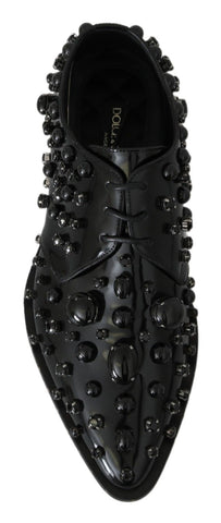 Black leather brogue shoes with crystal embellishments by Dolce & Gabbana, featuring classic lace-up design and detailed stitching.