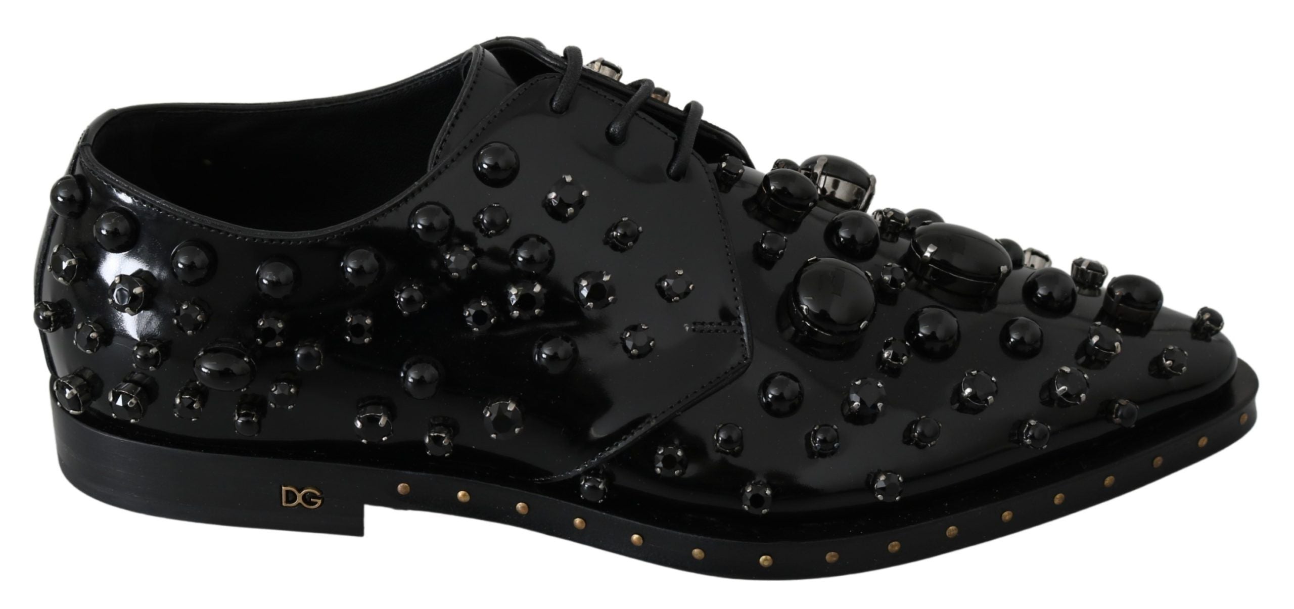 Black leather brogue shoes with crystal embellishments by Dolce & Gabbana, featuring detailed stitching and classic design.