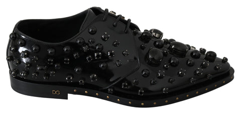 Black leather brogue shoes with crystal embellishments by Dolce & Gabbana, featuring detailed stitching and classic design.