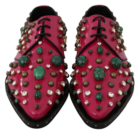 Pink leather brogue shoes with crystal embellishments by Dolce & Gabbana, featuring detailed stitching and classic design.
