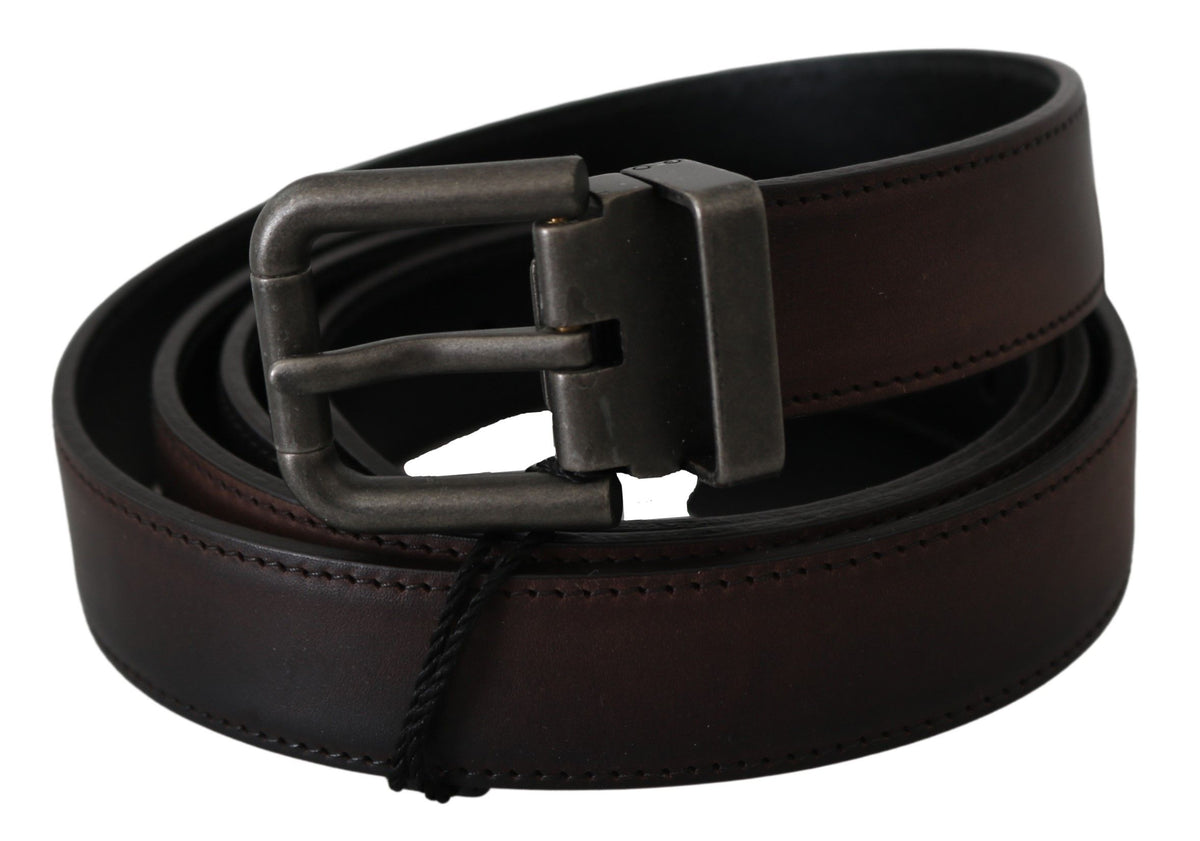 Solid brown leather belt with gray buckle from Dolce & Gabbana, featuring a sleek, classic design and durable craftsmanship.
