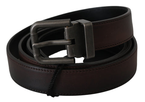 Solid brown leather belt with gray buckle from Dolce & Gabbana, featuring a sleek, classic design and durable craftsmanship.
