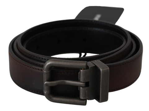Solid brown leather belt with gray buckle from Dolce & Gabbana, featuring a sleek design and durable leather strap.