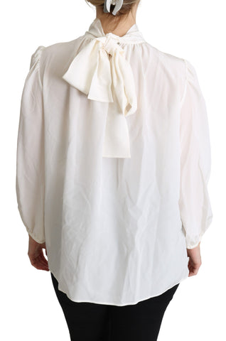 White silk pussy bow long-sleeved blouse by Dolce & Gabbana, featuring a feminine bow detail and elegant long sleeves.