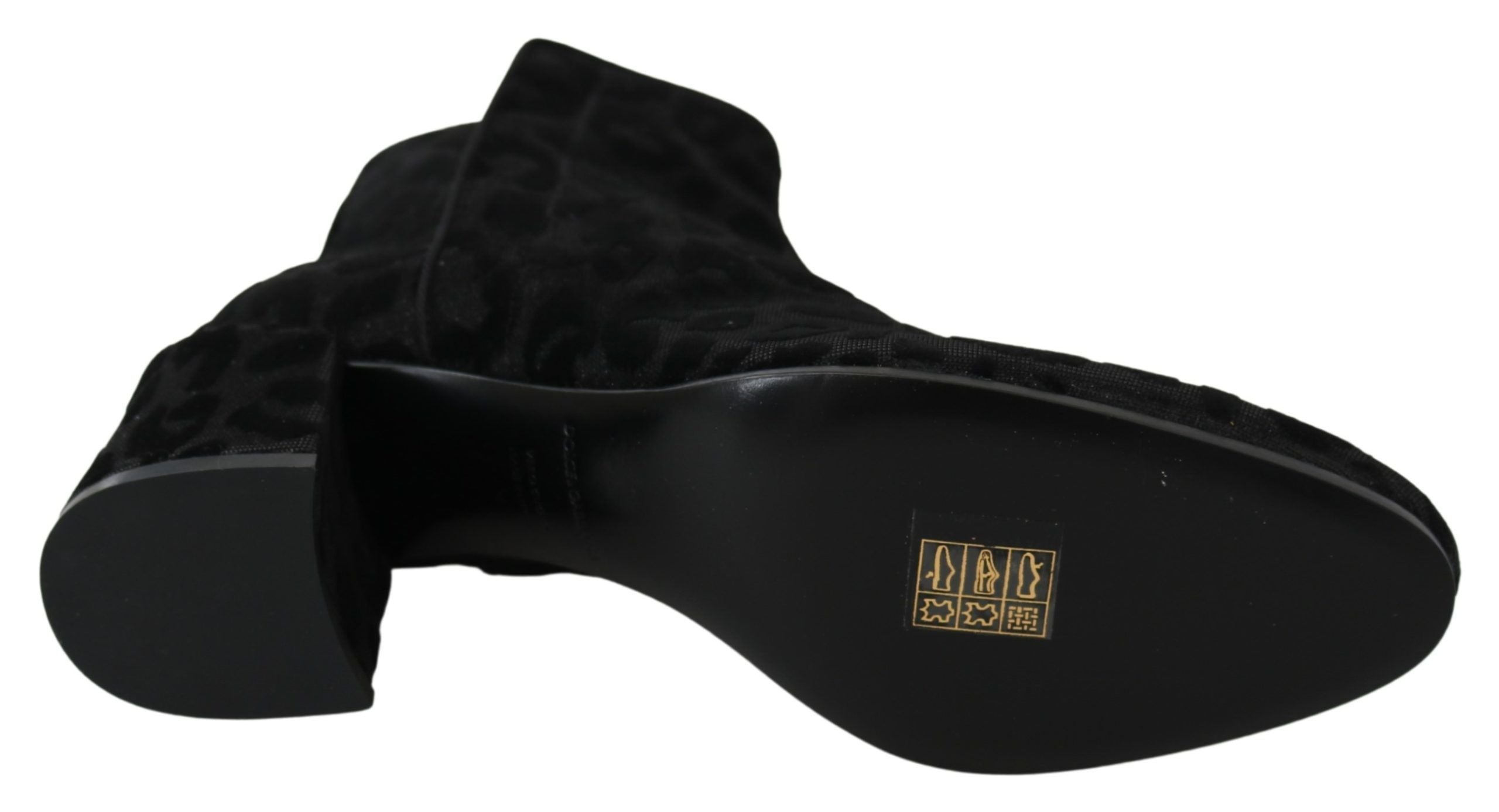 Black leopard-print Dolce & Gabbana short boots with zipper closure, stylish and trendy footwear in a sleek design.