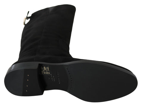 Black suede knee-high flat boots from Dolce & Gabbana, featuring sleek design and pointed toes.