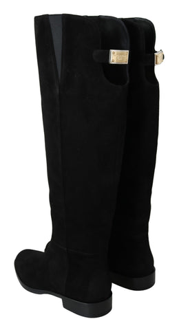 Black suede knee-high flat boots by Dolce & Gabbana, featuring sleek design and pointed toes.
