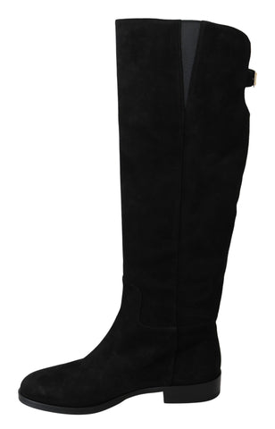 Black suede knee-high flat boots by Dolce & Gabbana, showcasing smooth texture and sleek design for stylish winter footwear.