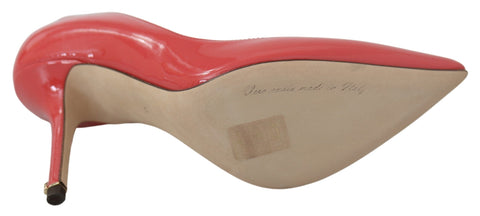 Dark pink patent leather Dolce & Gabbana heels pumps with pointed toes and stiletto heels.