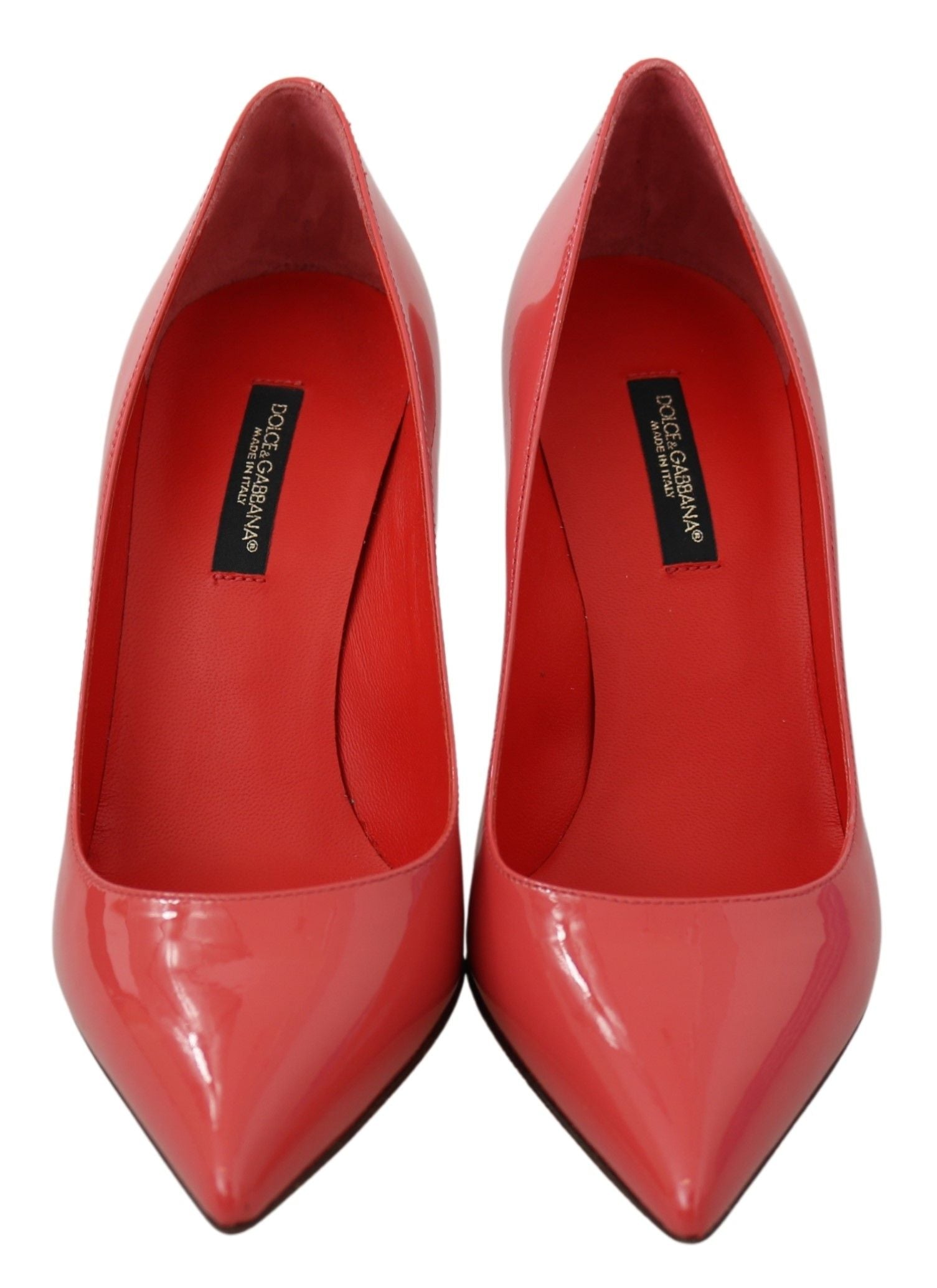 Dark pink patent leather Dolce & Gabbana heels pumps with pointed toes and stiletto heels.
