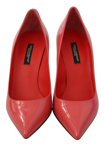 Dark pink patent leather Dolce & Gabbana heels pumps with pointed toes and stiletto heels.