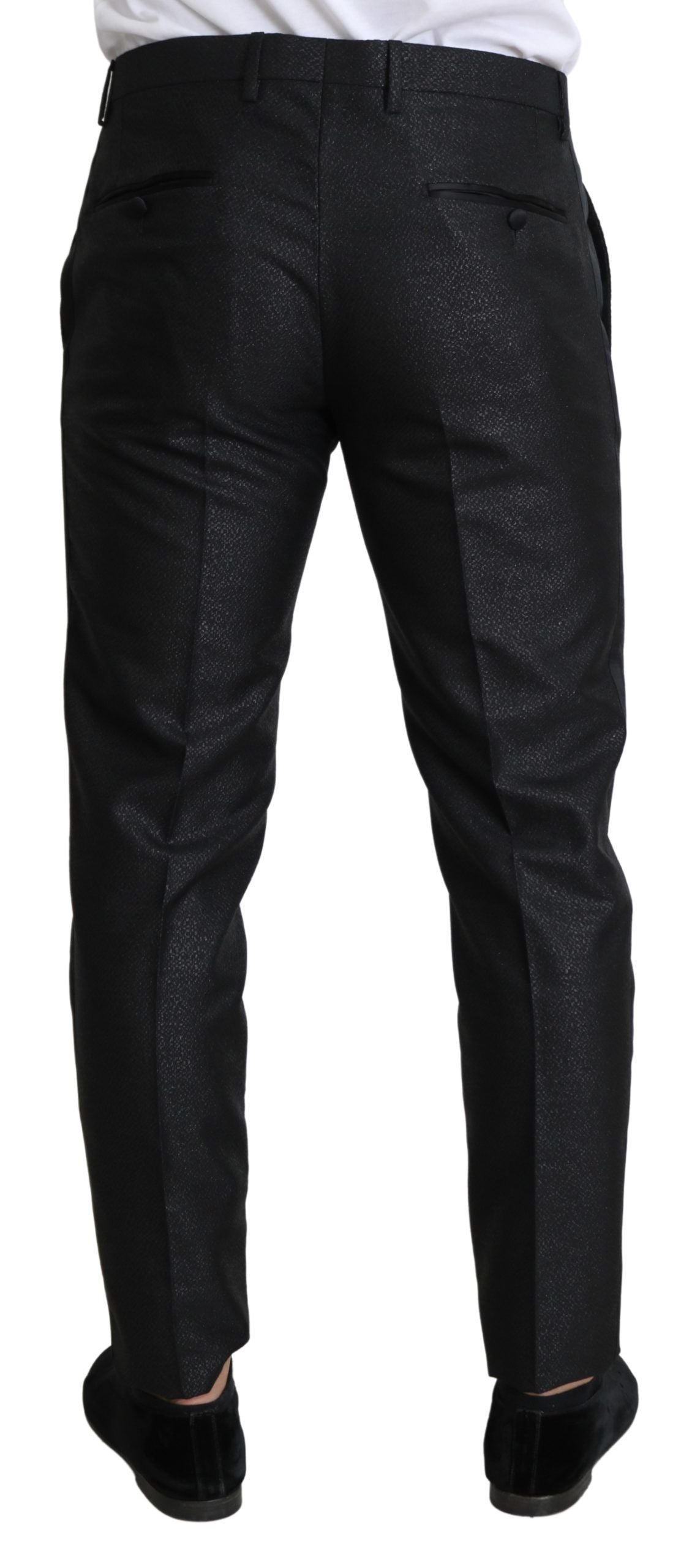 Black metallic skinny trouser dress by Dolce & Gabbana, featuring a sleek fitted silhouette and shiny metallic fabric.
