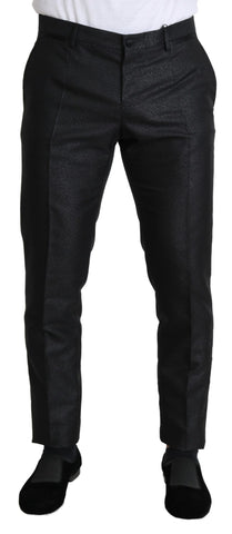Black metallic skinny trouser dress by Dolce & Gabbana, close-up showing shiny fabric and fitted silhouette.