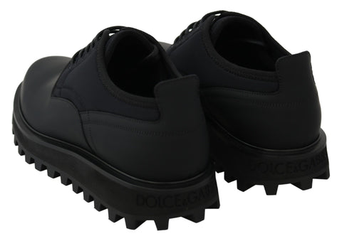Black rubberized calfskin chunky derby shoes by Dolce & Gabbana, showcasing a sleek, stylish design with a sturdy sole.
