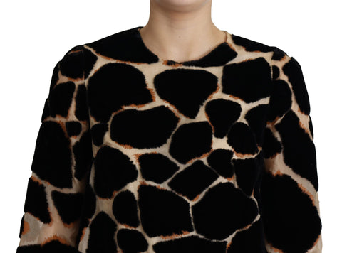 Dolce & Gabbana black giraffe print shift mini dress with long sleeves and round neckline, shown on a model.