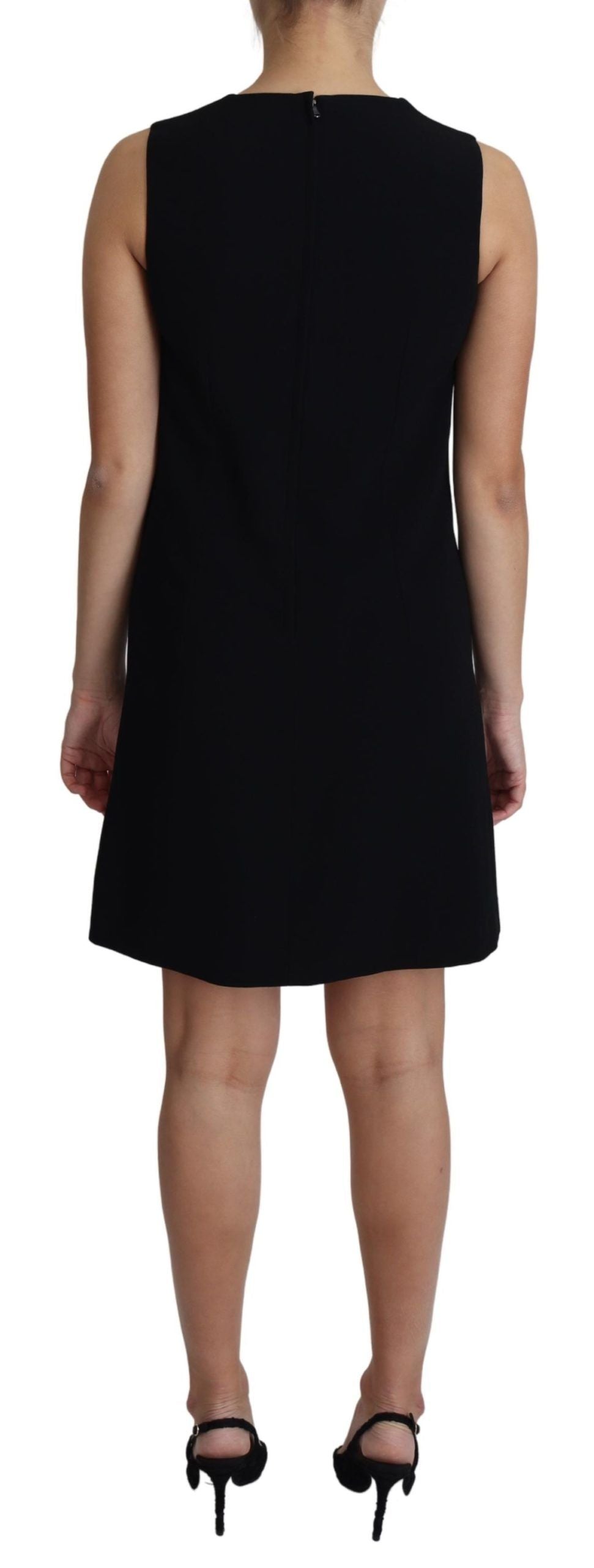 Black viscose stretch A-line shift mini dress by Dolce & Gabbana hanging on a clothing rack, showcasing its sleek silhouette.