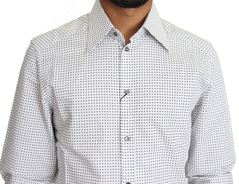 Black and white polka dot dress shirt by Dolce & Gabbana, featuring long sleeves and classic collar, laid flat.