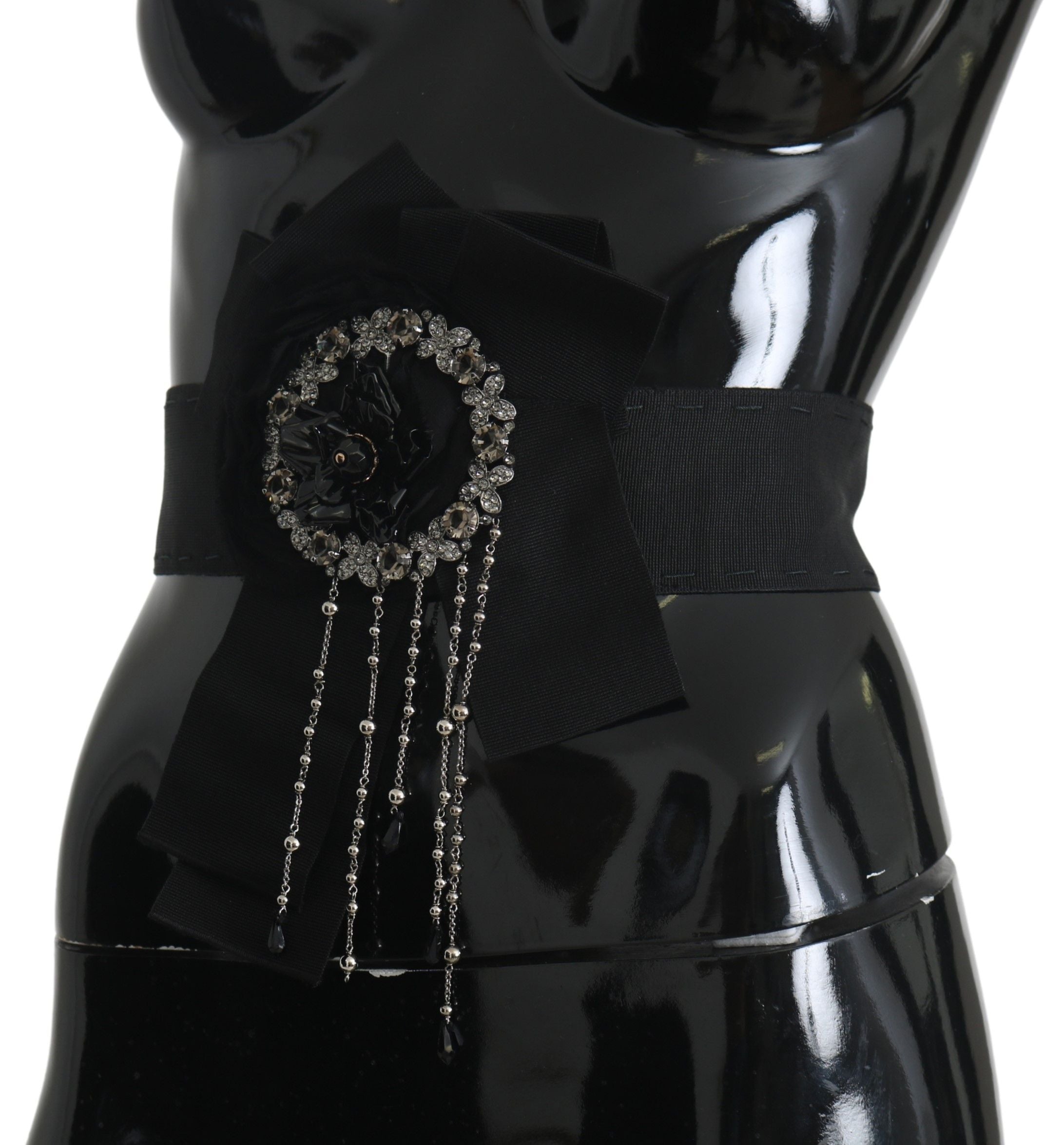 Black crystal brooch and wide wai Satoria belt from Dolce & Gabbana, featuring intricate crystal detailing and elegant design.