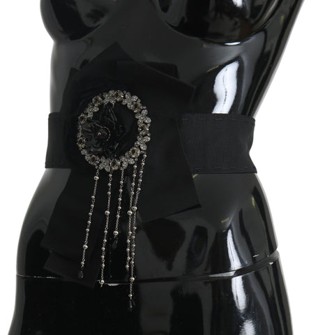 Black crystal brooch and wide wai Satoria belt from Dolce & Gabbana, featuring intricate crystal detailing and elegant design.