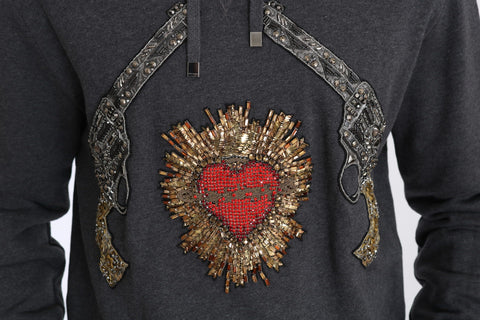 Gray hooded sweater with red crystal heart and gun graphic by Dolce & Gabbana, featuring a casual, stylish design.