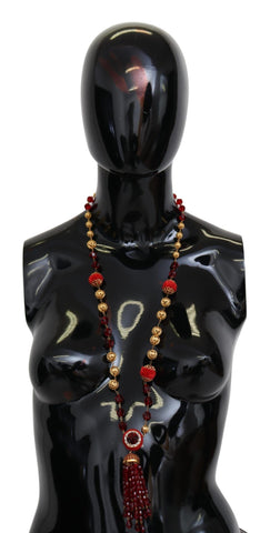 Gold tone brass necklace with red crystal pendant and opera chain from Dolce & Gabbana, featuring a luxurious, elegant design.