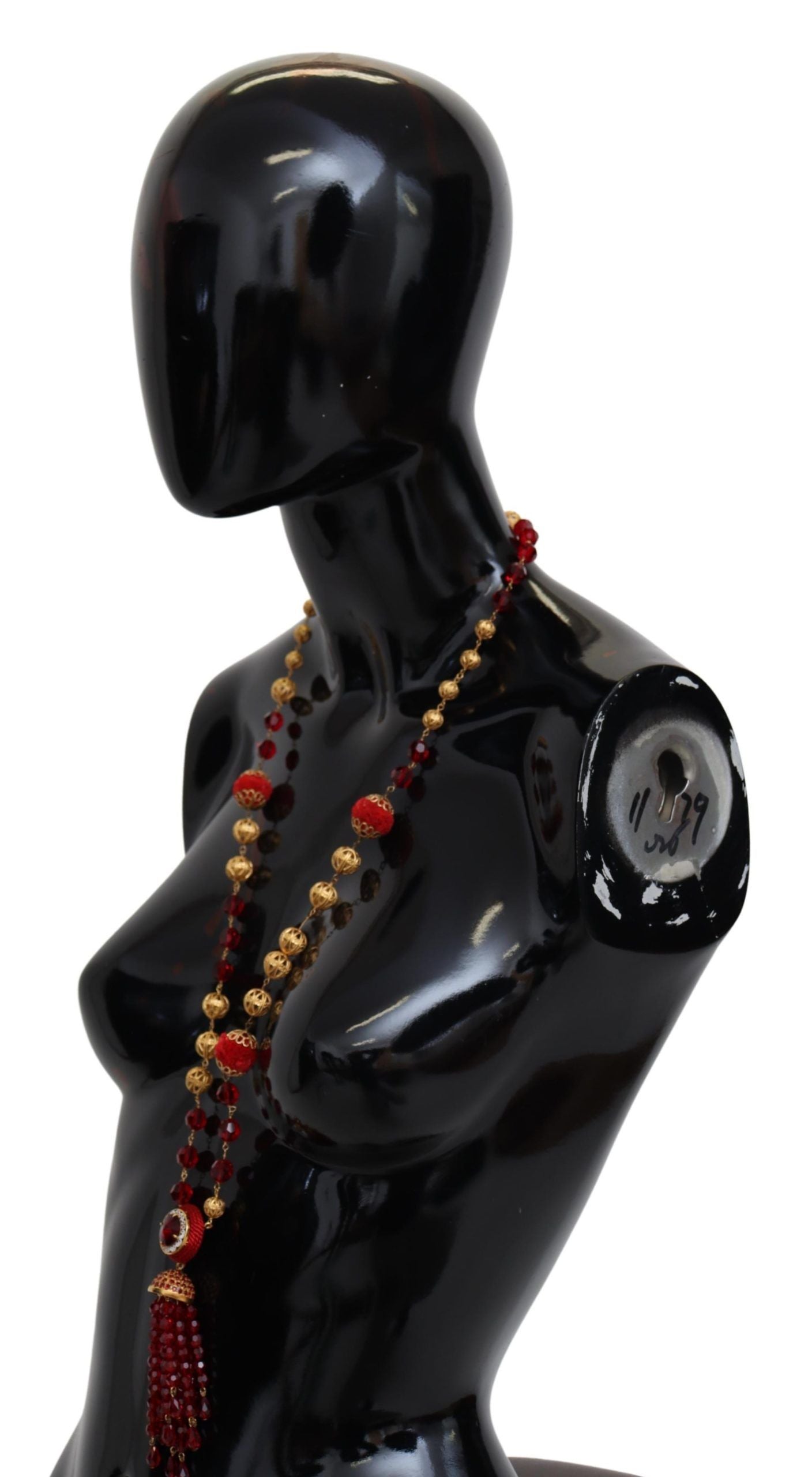 Gold tone brass necklace with red crystal pendant on opera chain, designed by Dolce & Gabbana.