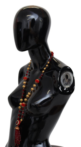 Gold tone brass necklace with red crystal pendant on opera chain, designed by Dolce & Gabbana.